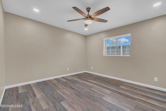 empty room with ceiling fan and hardwood / wood-style floors