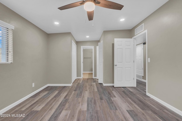 unfurnished room featuring hardwood / wood-style floors and ceiling fan