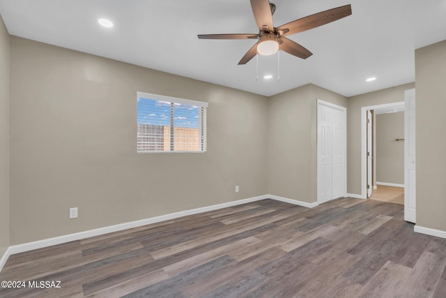 spare room with hardwood / wood-style floors and ceiling fan