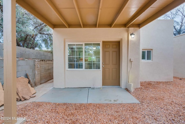 view of exterior entry featuring a patio area