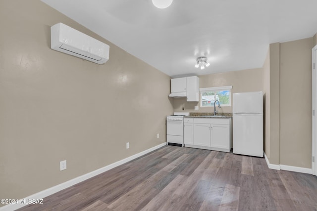 kitchen with sink, white appliances, white cabinetry, a wall mounted air conditioner, and light wood-type flooring