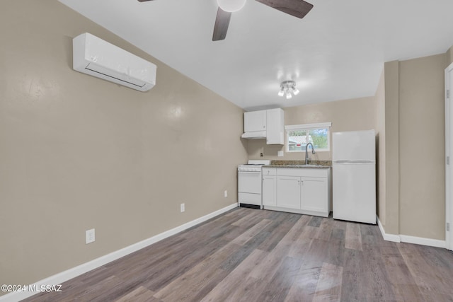 kitchen featuring sink, white cabinetry, range, white refrigerator, and a wall unit AC