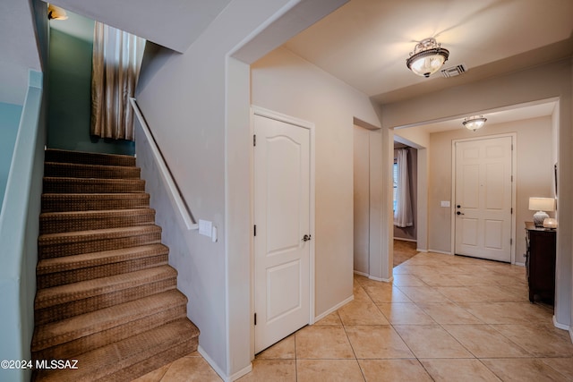 stairway featuring tile patterned floors