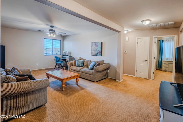 living room with ceiling fan and light colored carpet