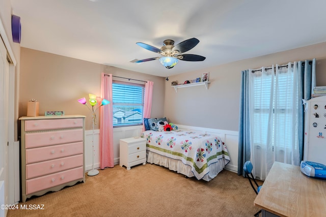 carpeted bedroom with ceiling fan and a closet