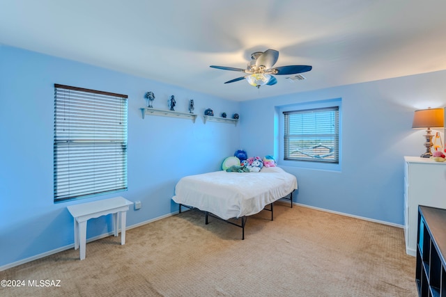 bedroom with light colored carpet and ceiling fan