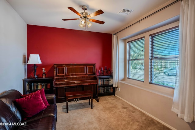 living area featuring ceiling fan and light carpet