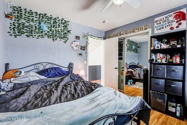 bedroom with ceiling fan, a closet, and light wood-type flooring