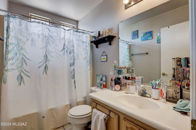 bathroom featuring vanity, a textured ceiling, and toilet