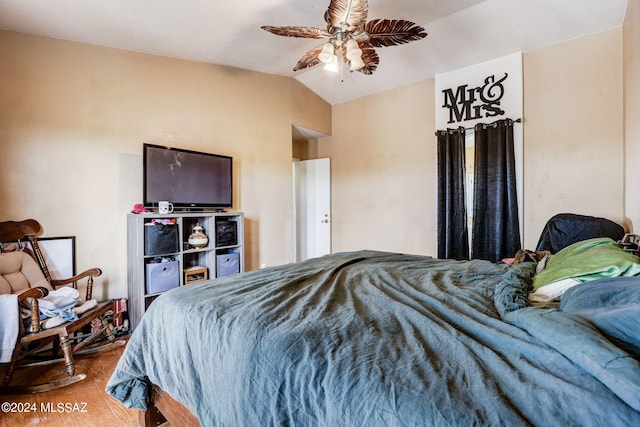 bedroom with wood-type flooring, ceiling fan, and lofted ceiling