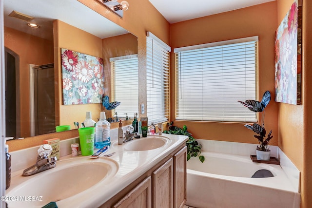 bathroom featuring dual sinks, independent shower and bath, and oversized vanity