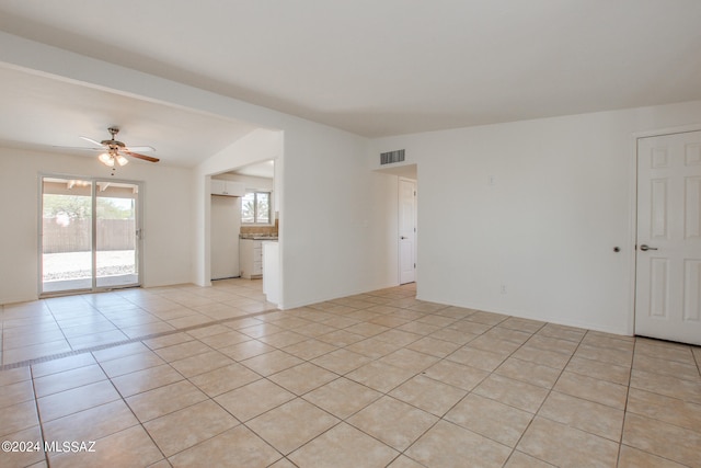 tiled empty room with ceiling fan