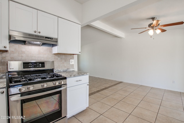 kitchen featuring backsplash, ceiling fan, white cabinets, stainless steel gas range, and light tile floors