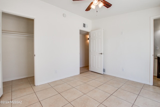 unfurnished bedroom featuring a closet, ceiling fan, and light tile flooring