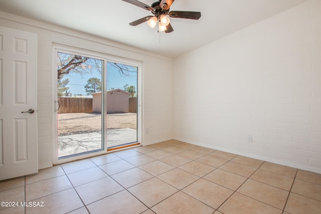 tiled spare room featuring ceiling fan