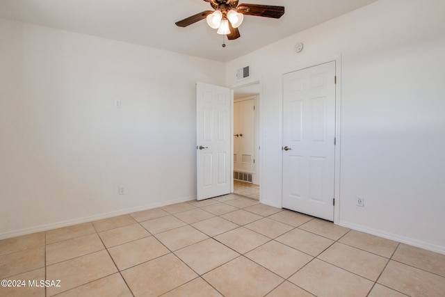 unfurnished bedroom with ceiling fan and light tile floors