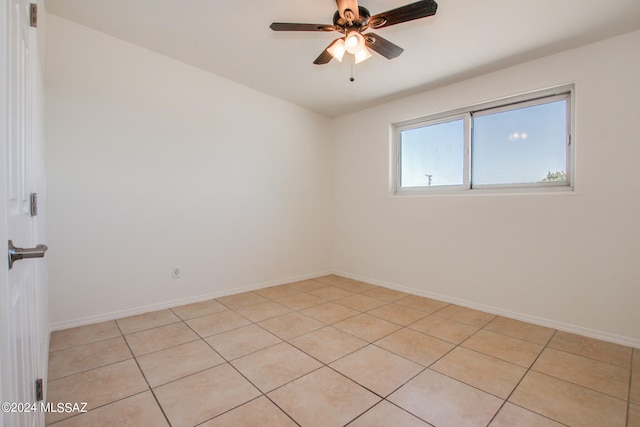 tiled empty room featuring ceiling fan