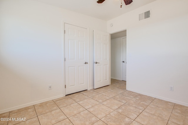 interior space with ceiling fan and light tile floors