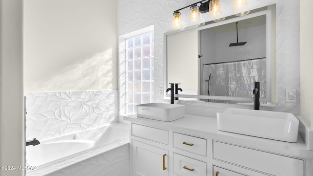 bathroom featuring double sink vanity and a relaxing tiled bath