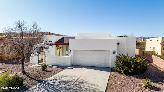 pueblo-style home featuring a garage