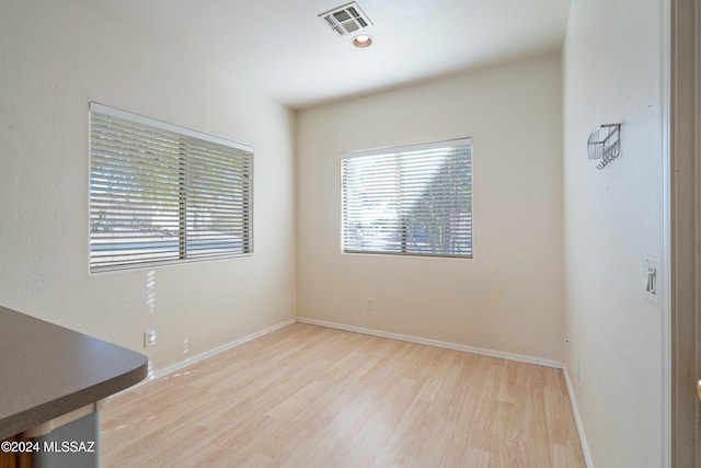 spare room featuring light wood-type flooring