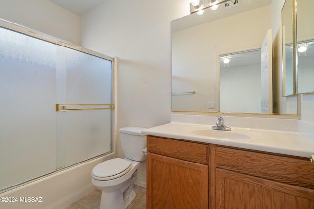 full bathroom with ceiling fan, tile patterned floors, toilet, shower / bath combination with glass door, and vanity