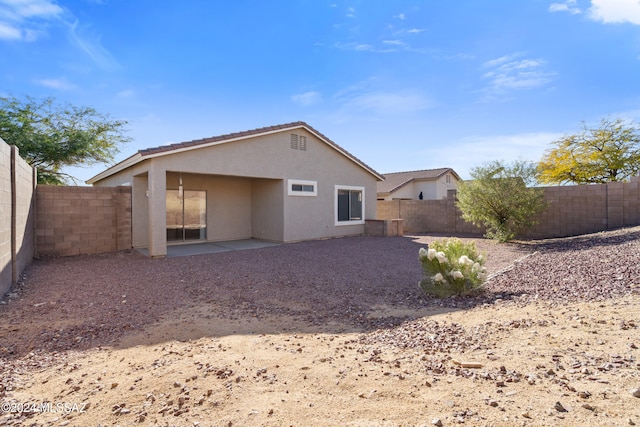 rear view of property featuring a patio area