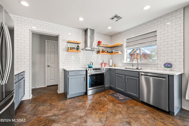 kitchen with appliances with stainless steel finishes, tasteful backsplash, sink, and wall chimney range hood