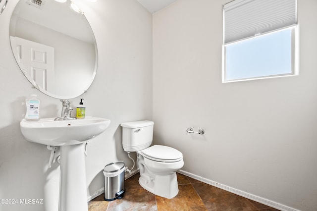 bathroom with toilet and tile flooring