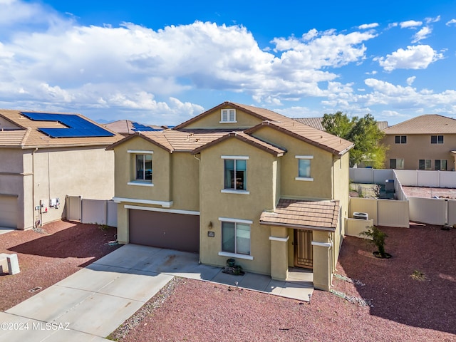 view of front of house with solar panels and a garage