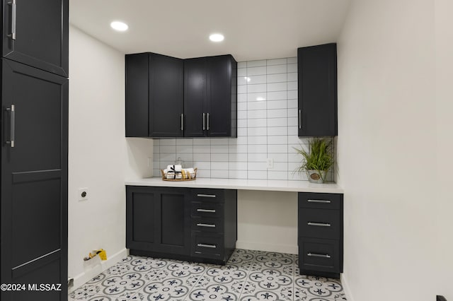 kitchen featuring light tile flooring and backsplash