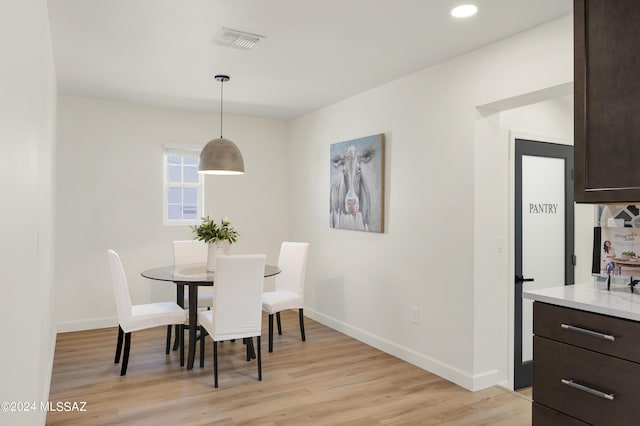 dining area with light hardwood / wood-style flooring