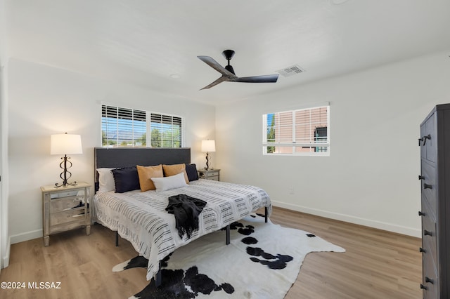 bedroom with light hardwood / wood-style floors and ceiling fan