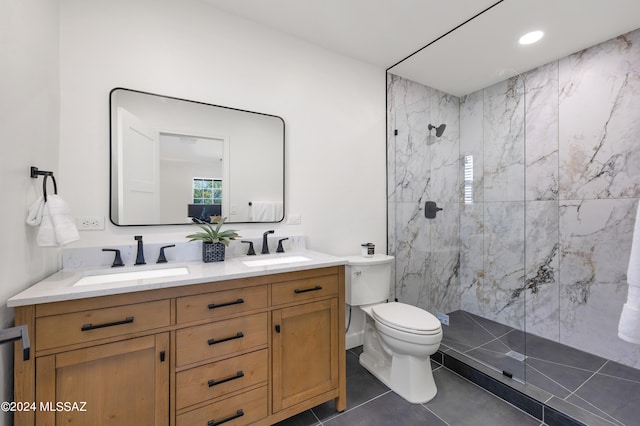 bathroom with walk in shower, dual sinks, toilet, and oversized vanity