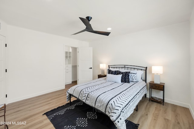 bedroom with ceiling fan and light wood-type flooring