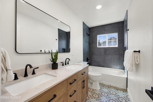 full bathroom with tiled shower / bath combo, dual bowl vanity, tile flooring, and toilet