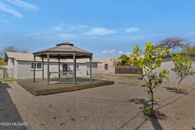 exterior space with a wooden deck and a gazebo