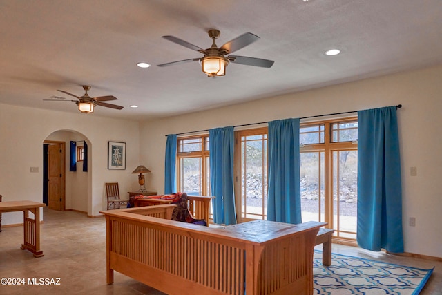 interior space with access to exterior, ceiling fan, and multiple windows