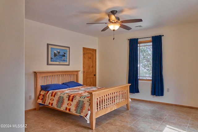 bedroom featuring ceiling fan and light tile floors