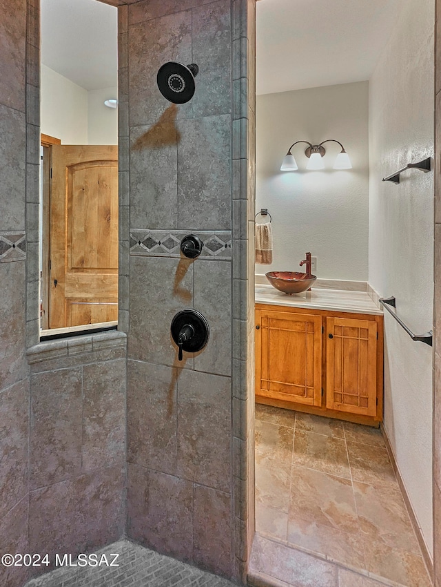 bathroom with vanity and tiled shower