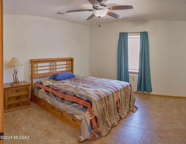 bedroom featuring ceiling fan and light tile floors