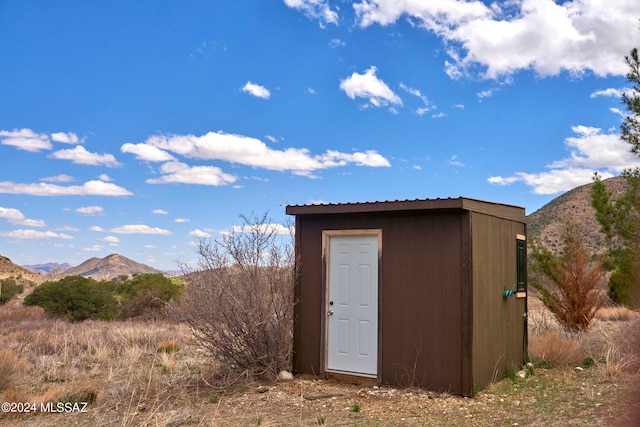 view of shed / structure with a mountain view