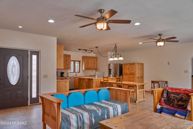 living room with ceiling fan, rail lighting, and light tile floors