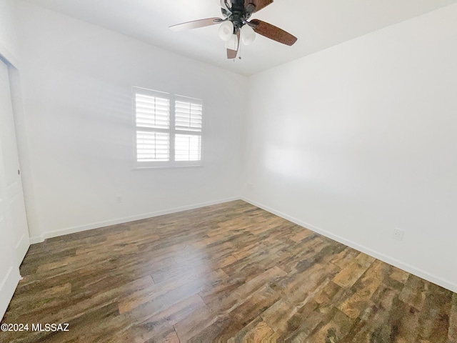 unfurnished room featuring a ceiling fan, baseboards, and wood finished floors