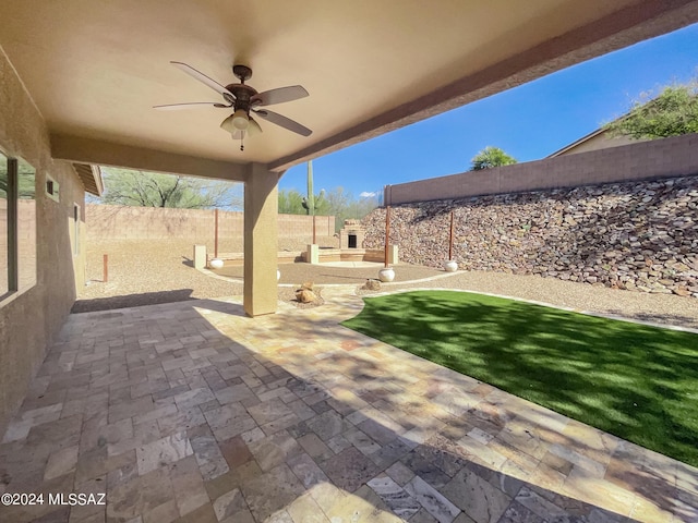 view of patio / terrace featuring a fenced backyard and a ceiling fan