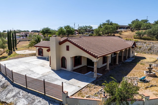 mediterranean / spanish house with a patio area