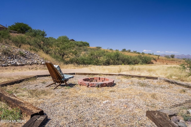 view of yard with a rural view and an outdoor fire pit