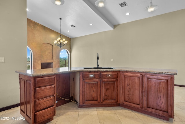 kitchen featuring pendant lighting, light tile patterned flooring, sink, a notable chandelier, and light stone countertops