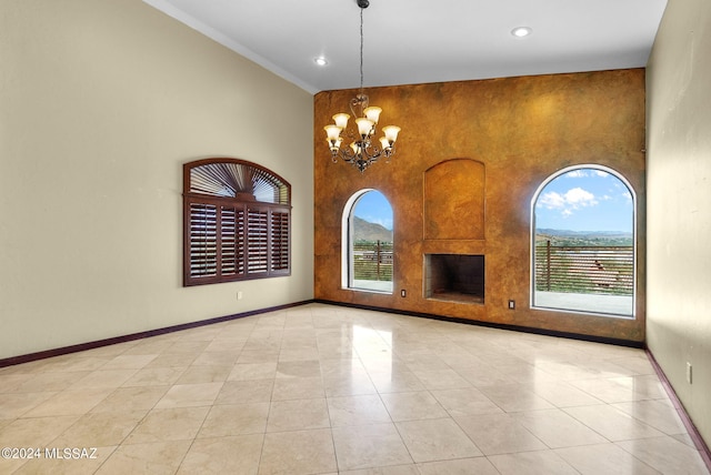 unfurnished room featuring an inviting chandelier, a towering ceiling, and light tile patterned flooring