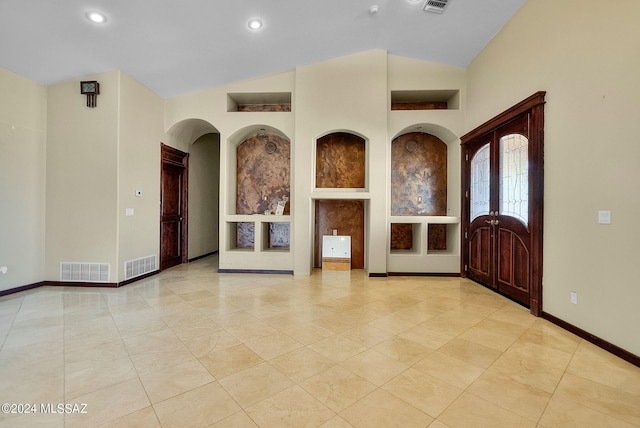 tiled foyer featuring vaulted ceiling